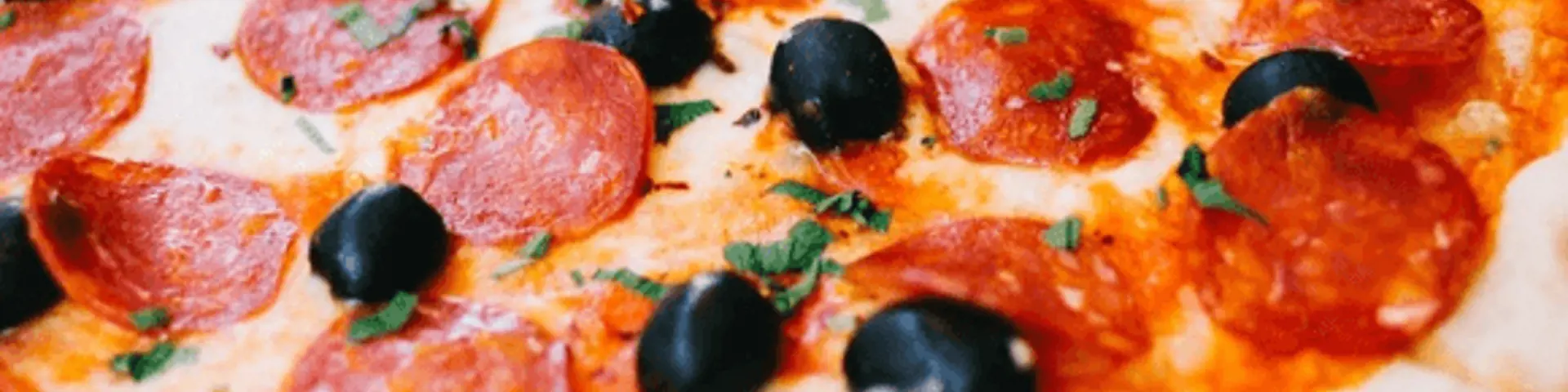 Pizza på grill med pepperoni og sorte oliven